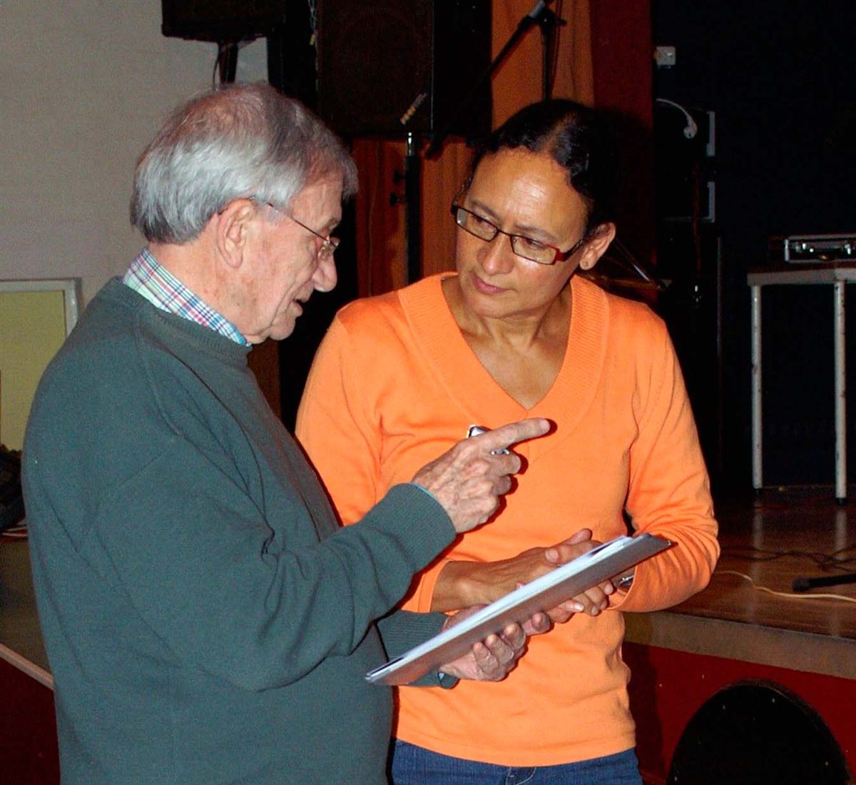 Two participants discussing sheet music at the festival