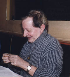 Claude Garden smiling, seated at a table